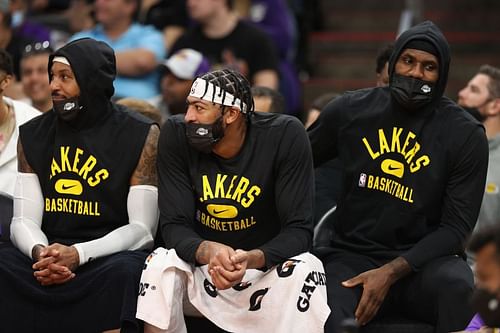 The LA Lakers' LeBron James on the bench with Anthony Davis and Carmelo Anthony