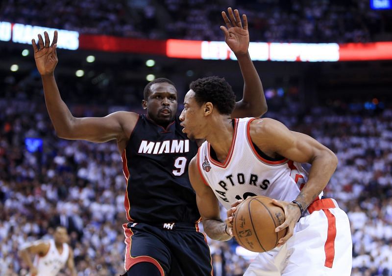 DeMar DeRozan (#10) of the Toronto Raptors dribbles the ball as Luol Deng (#9) of the Miami Heat