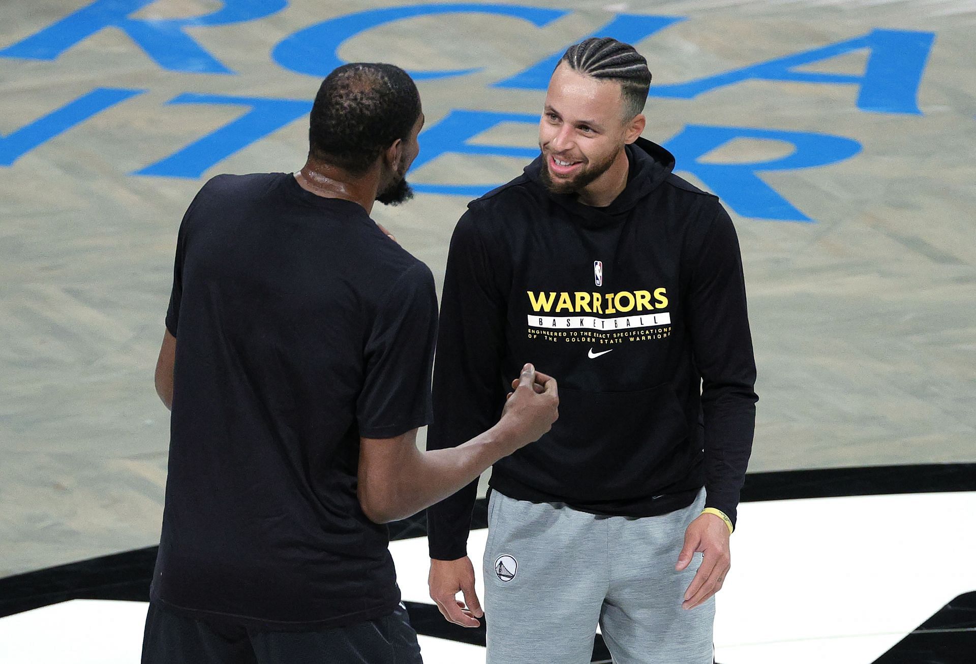 Stephen Curry of the Golden State Warriors with his former teammate Kevin Durant