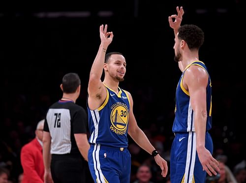 Stephen Curry and Klay Thompson celebrate with each other during an NBA game.