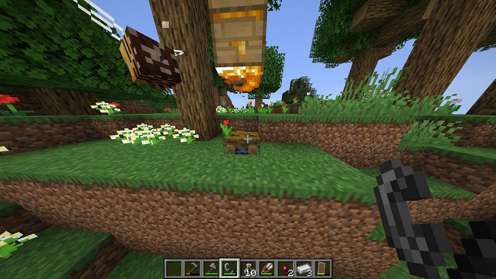 A campfire will pacify the bees so they can remove the beeswax without danger. Image via Minecraft