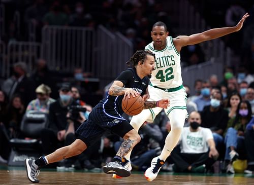 Al Horford (#42) of the Boston Celtics defends Cole Anthony (#50) of the Orlando Magic.