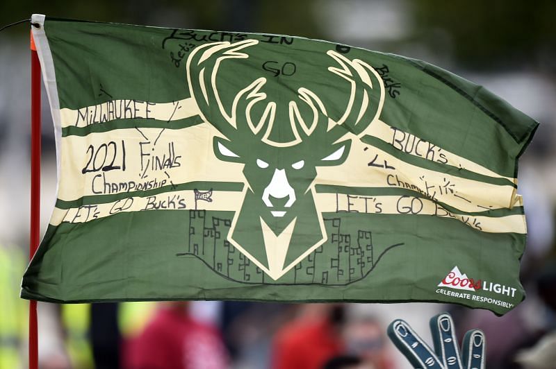 Fans hold a flag during the Milwaukee Bucks 2021 NBA Championship Victory Parade and Rally in the Deer District of Fiserv Forum on July 22, 2021 in Milwaukee, Wisconsin.