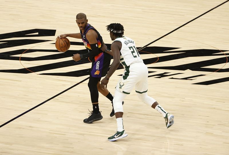 Jrue Holiday #21 of the Milwaukee Bucks defends against Chris Paul #3 of the Phoenix Suns during the second half in Game Two of the NBA Finals at Phoenix Suns Arena on July 08, 2021 in Phoenix, Arizona.