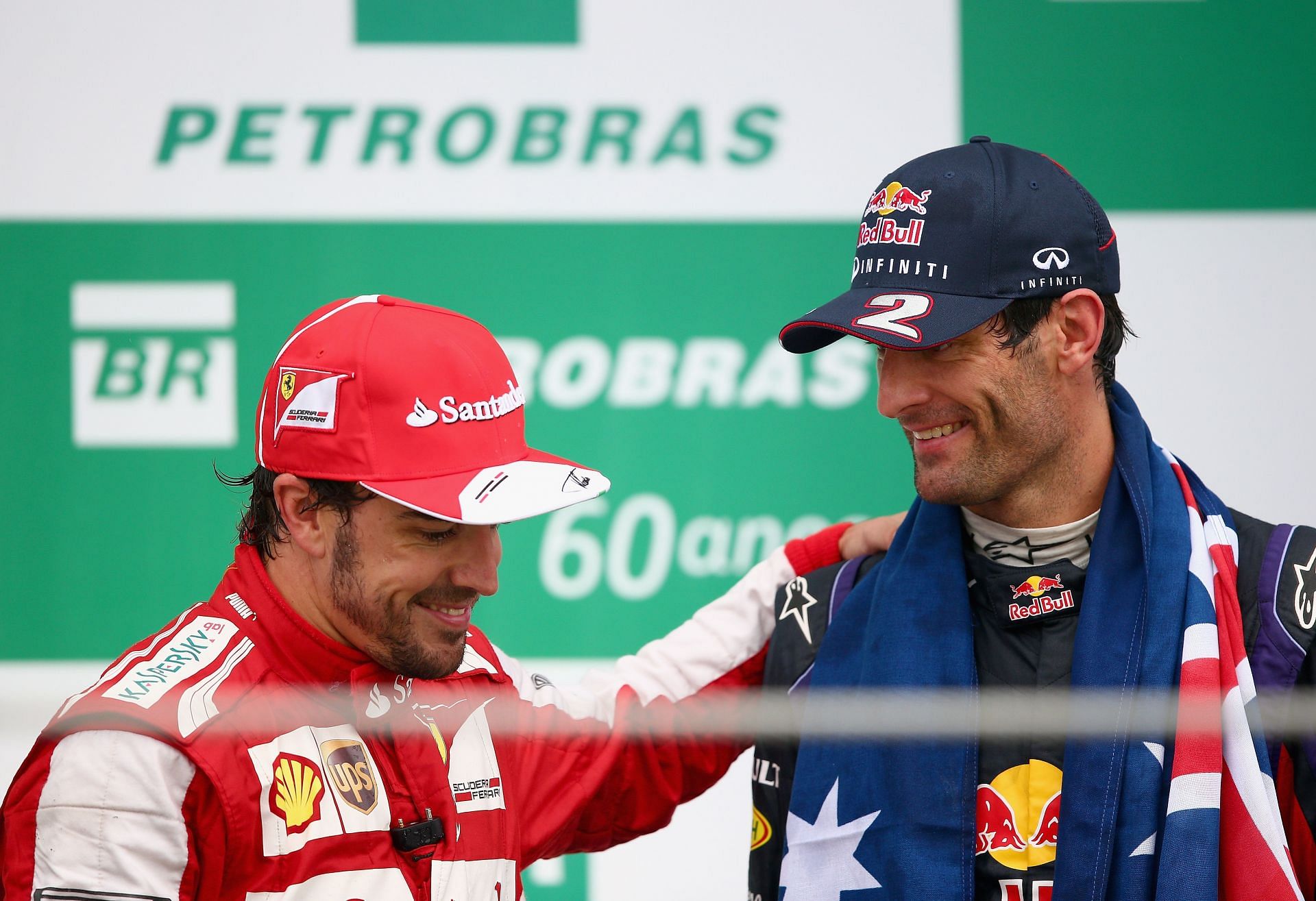Mark Webber of Infiniti Red Bull Racing and Fernando Alonso of Ferrari celebrate on the podium at the 2013 Brazilian GP. (Photo by Clive Mason/Getty Images)