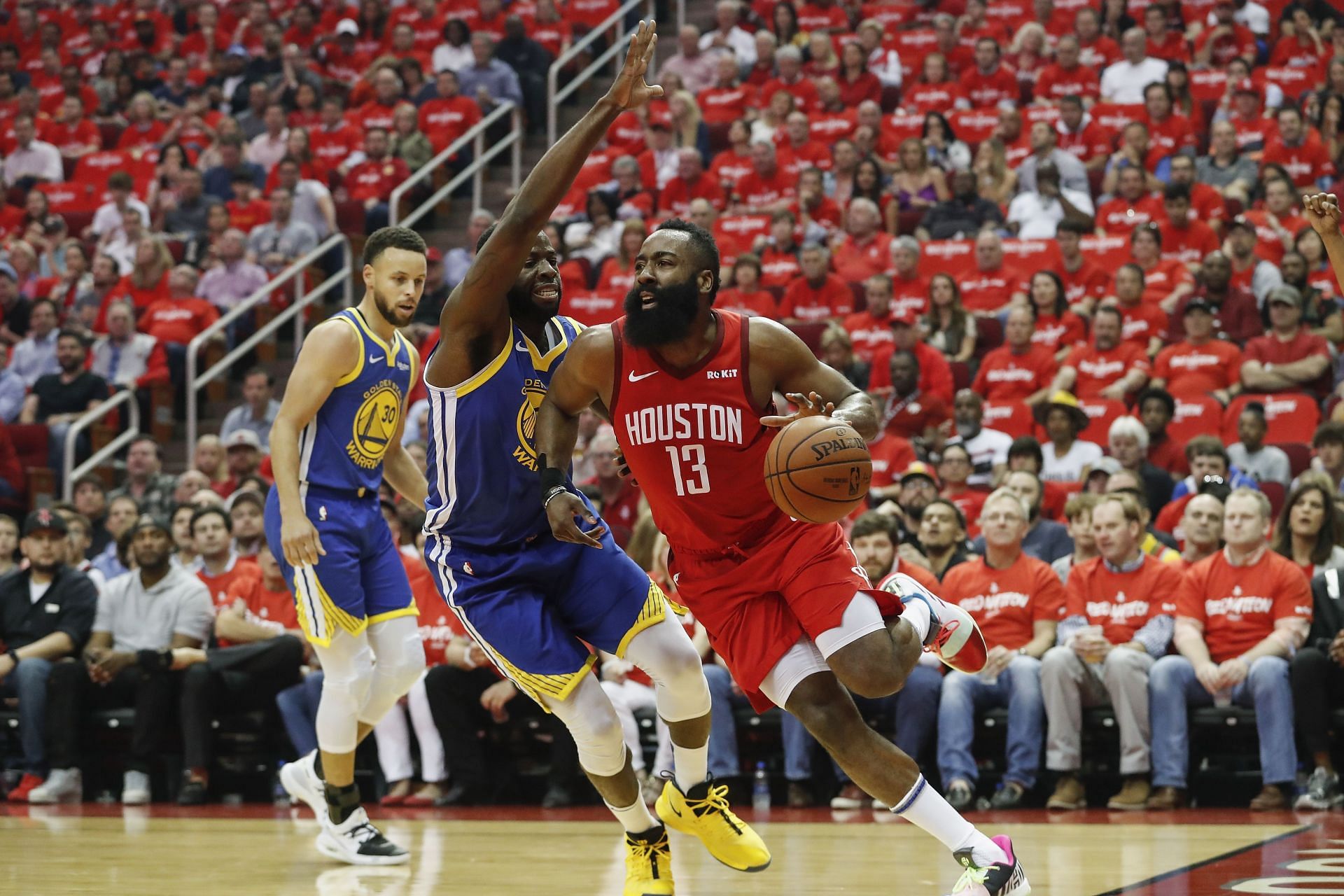 James Harden #13 of the Houston Rockets drives to the basket defended by Draymond Green #23 of the Golden State Warriors in the first quarter during Game Three of the Second Round of the 2019 NBA Western Conference Playoffs at Toyota Center on May 4, 2019 in Houston, Texas.