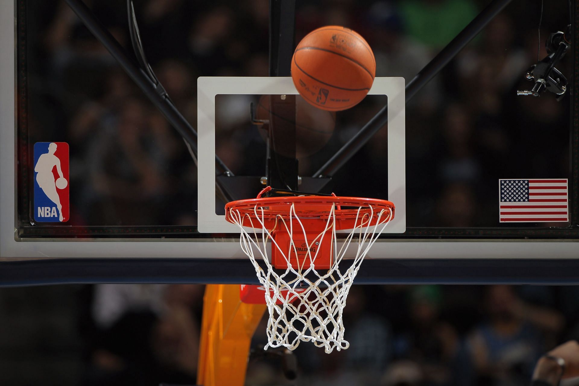 A detail photo of the ball as it falls through the rim during an NBA game.