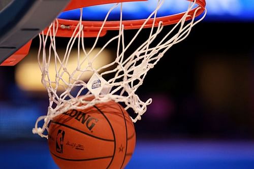 A detail of an official Spalding basketball going through the net with an official logo of the 2012 Orlando NBA All-Star Game