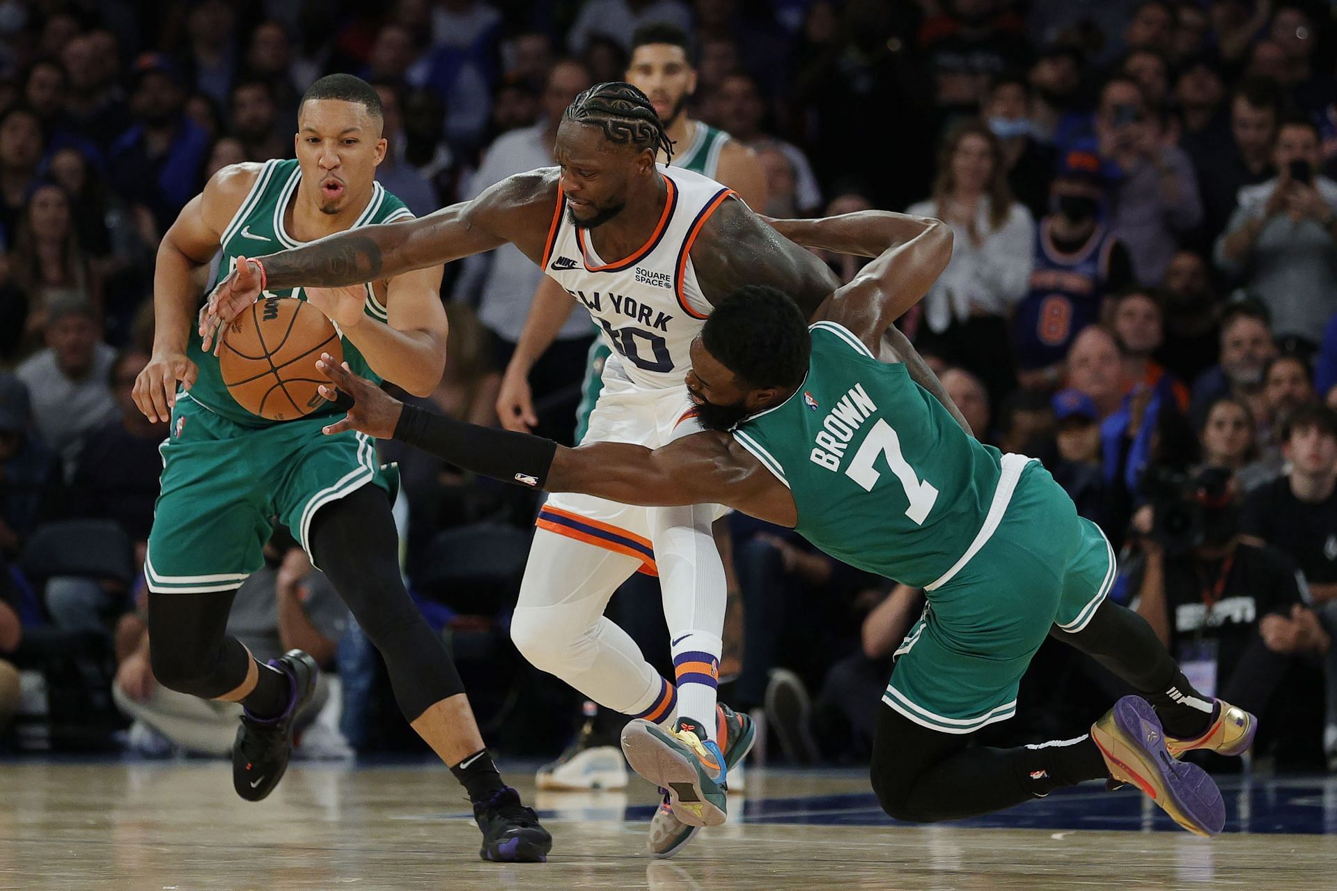 Julius Randle #30 of the New York Knicks battles Grant Williams #12 and Jaylen Brown #7 of the Boston Celtics