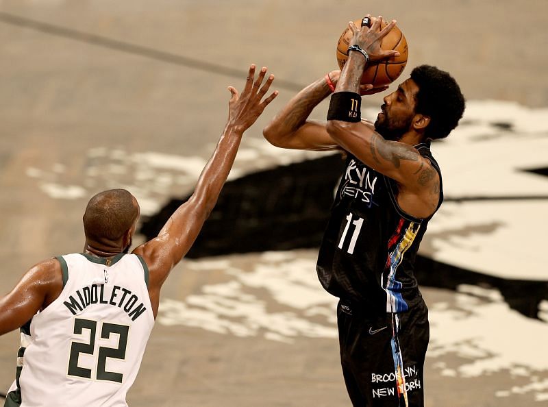 Milwaukee Bucks&#039; NBA star Khris Middleton defending Brooklyn Nets&#039;s Star Kyrie Irving&#039;s shot.