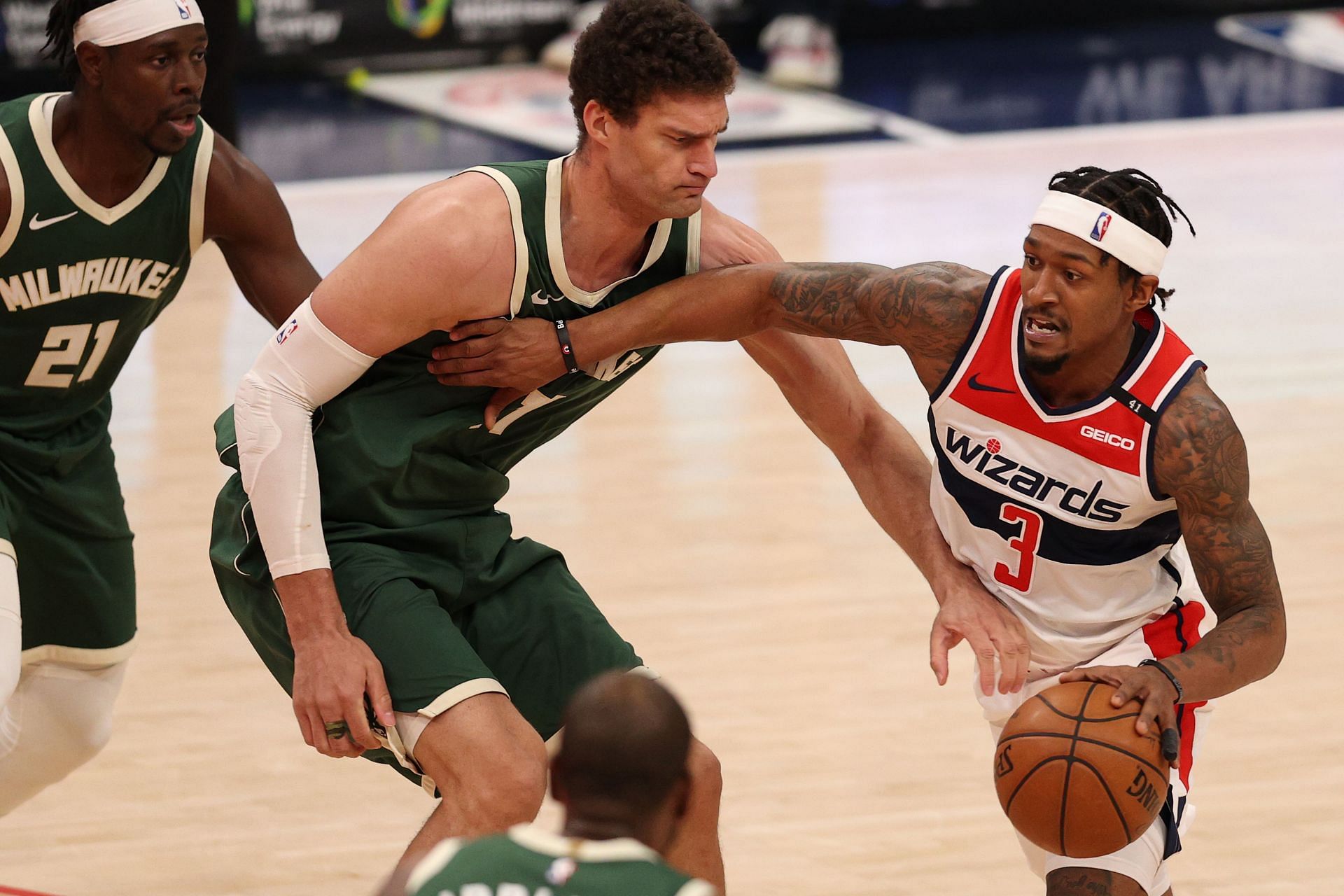 Bradley Beal #3 of the Washington Wizards dribbles past Brook Lopez #11 of the Milwaukee Bucks during the second half at Capital One Arena on March 15, 2021 in Washington, DC.