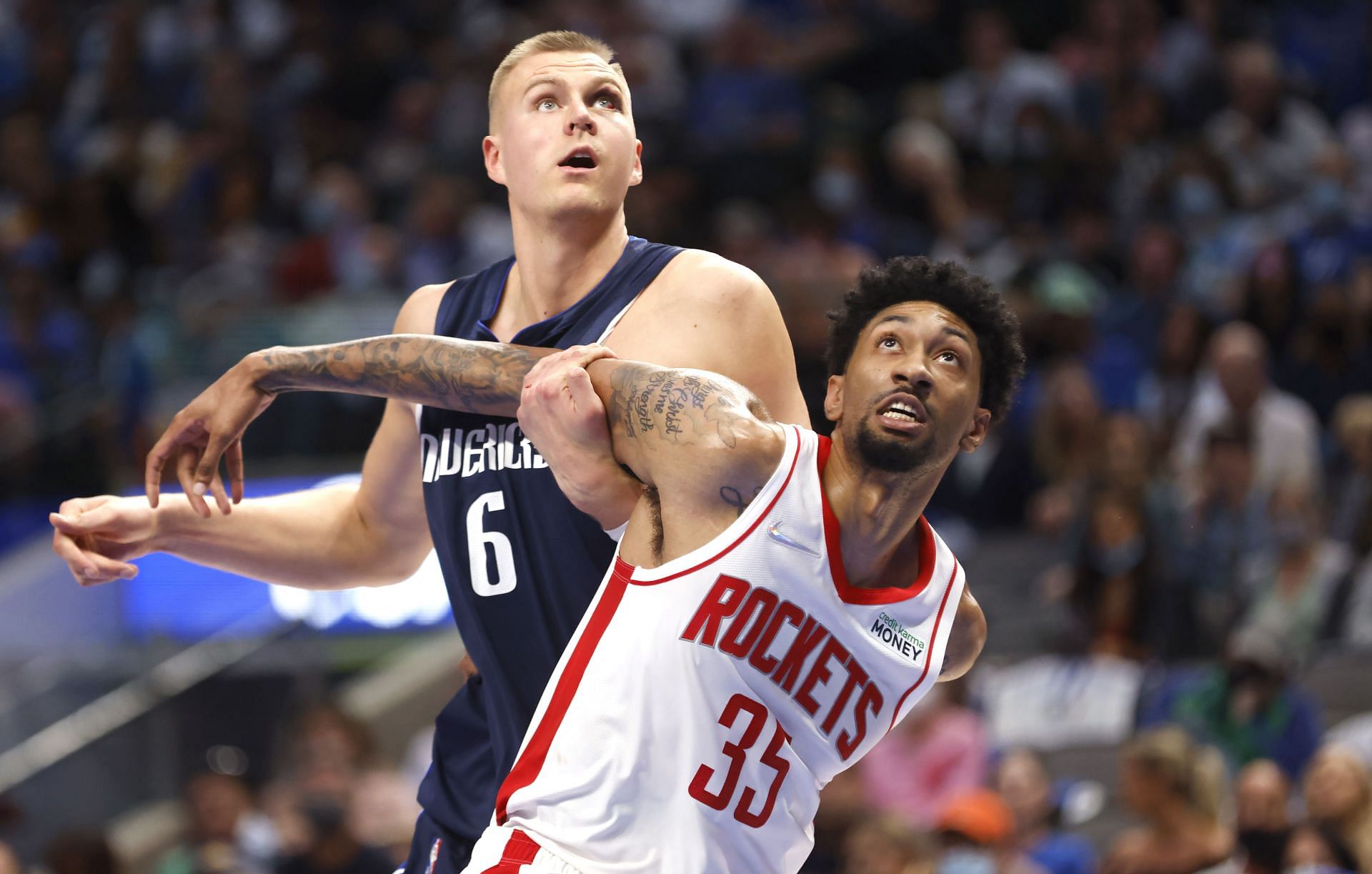 Dallas Mavericks star Kristaps Porzingis battles for a rebound with Christian Wood of the Houston Rockets