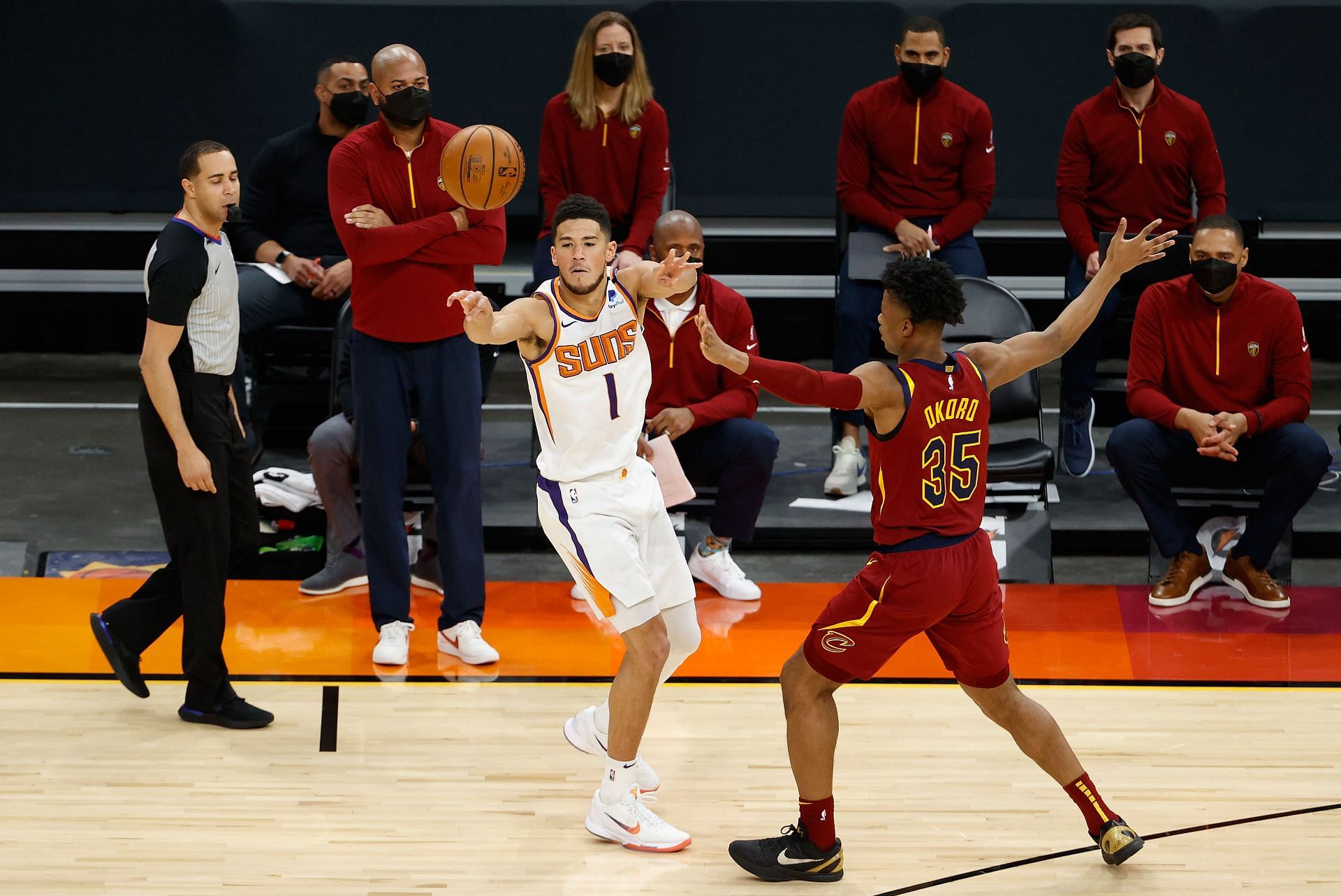 Devin Booker of the Phoenix Suns against Isaac Okoro of the Cleveland Cavaliers.