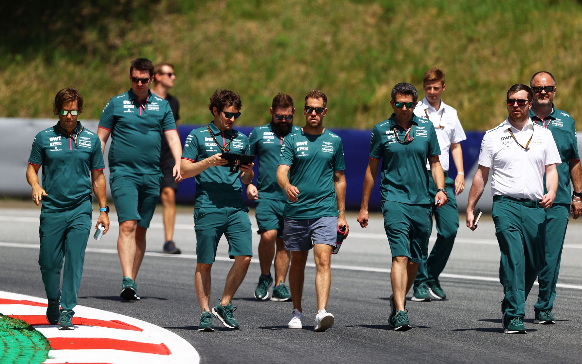Sebastian Vettel of Aston Martin F1 Team walks the track with his team during previews ahead of the F1 Grand Prix of Styria at Red Bull Ring in Spielberg, Austria. (Photo by Bryn Lennon/Getty Images)