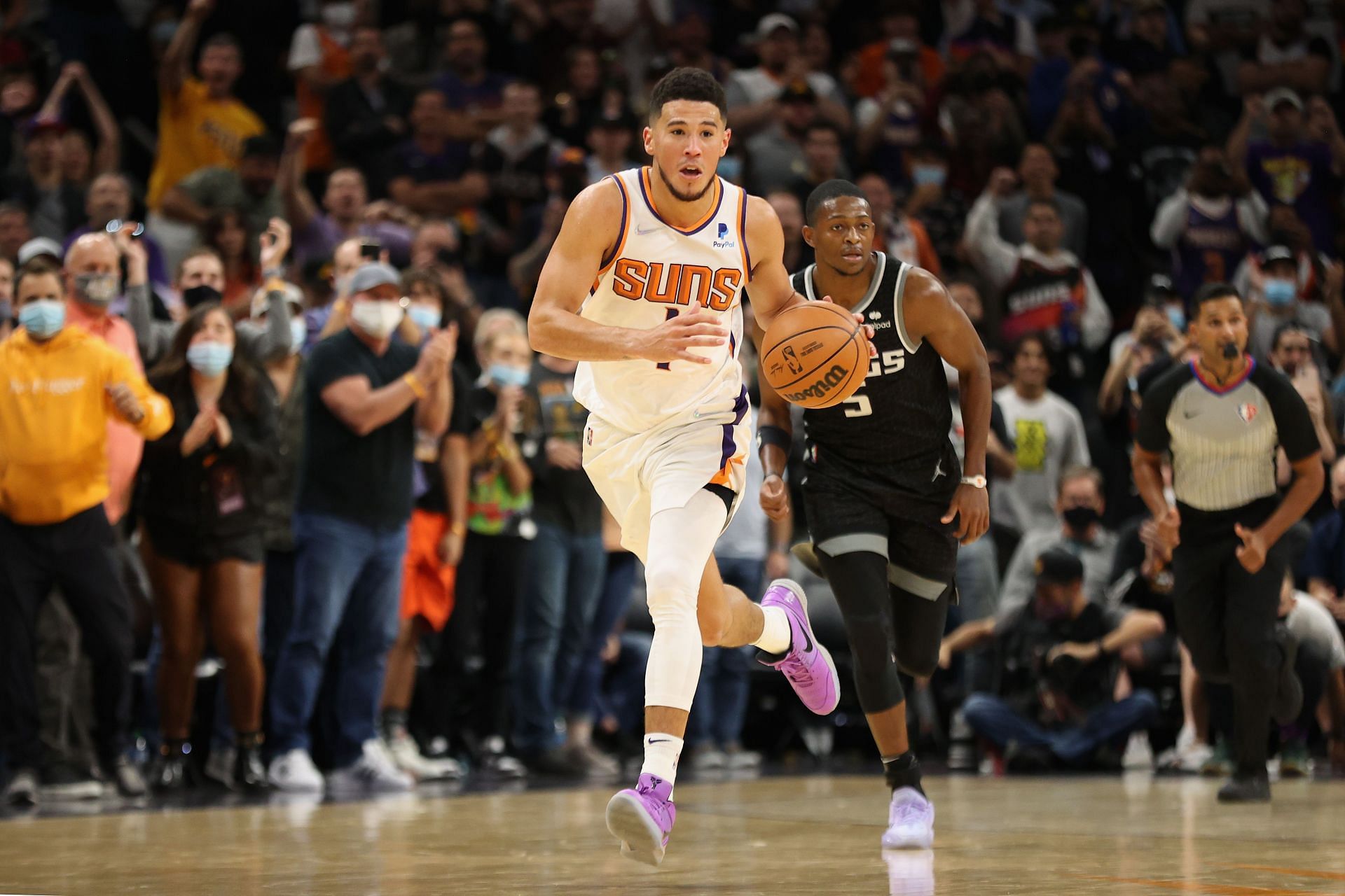 Devin Booker #1 of the Phoenix Suns drives the ball past De&#039;Aaron Fox #5 of the Sacramento Kings during the second half of the NBA game at Footprint Center on October 27, 2021 in Phoenix, Arizona.
