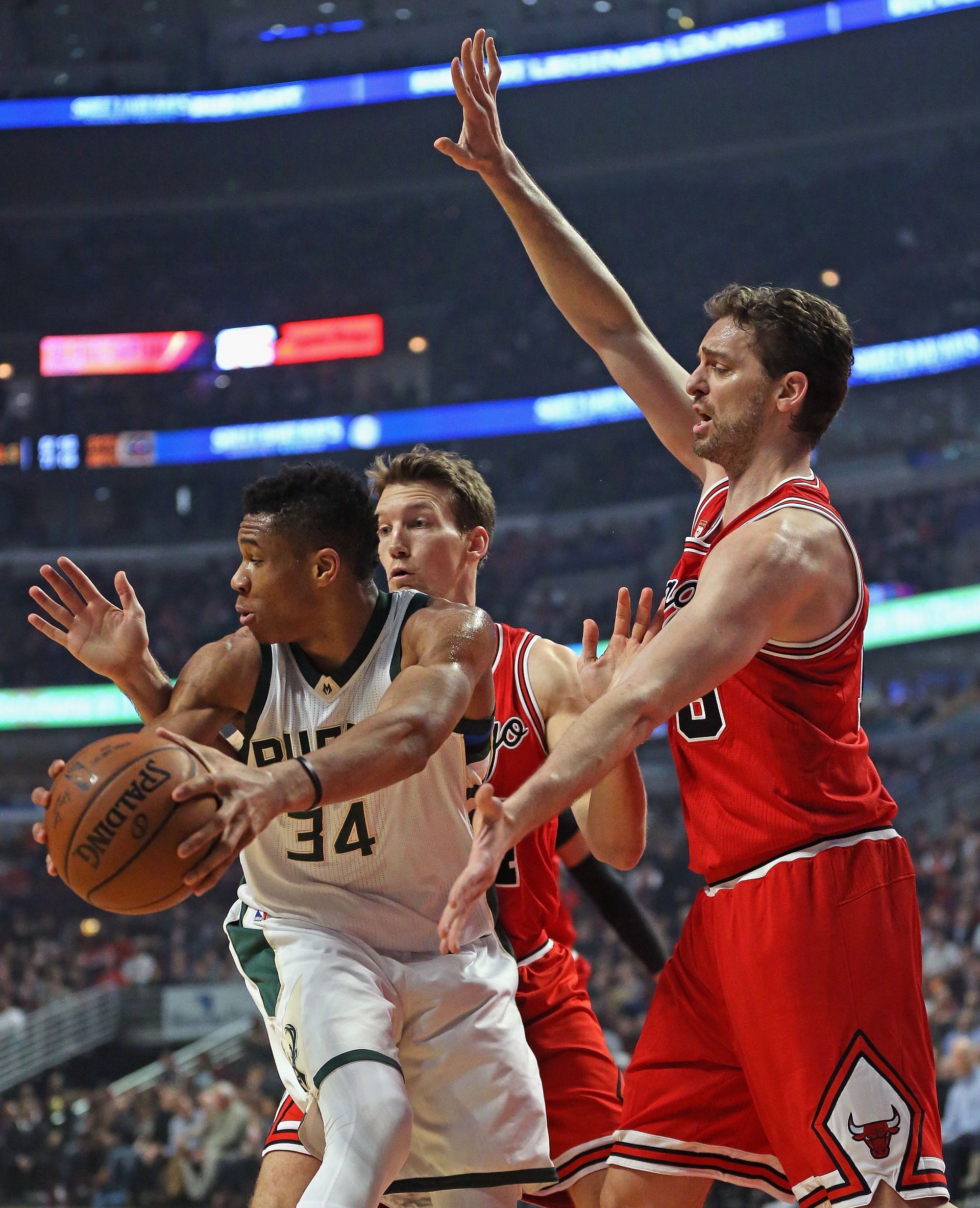 Giannis Antetokounmpo #34 of the Milwaukee Bucks looks to pass under pressure from Mike Dunleavy #34 (L) and Pau Gasol #16 of the Chicago Bulls at the United Center on March 7, 2016 in Chicago, Illinois.