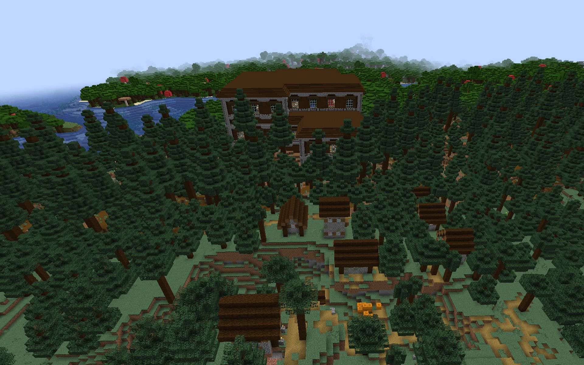 An image of a village and woodland mansion in-game (Image via Minecraft)