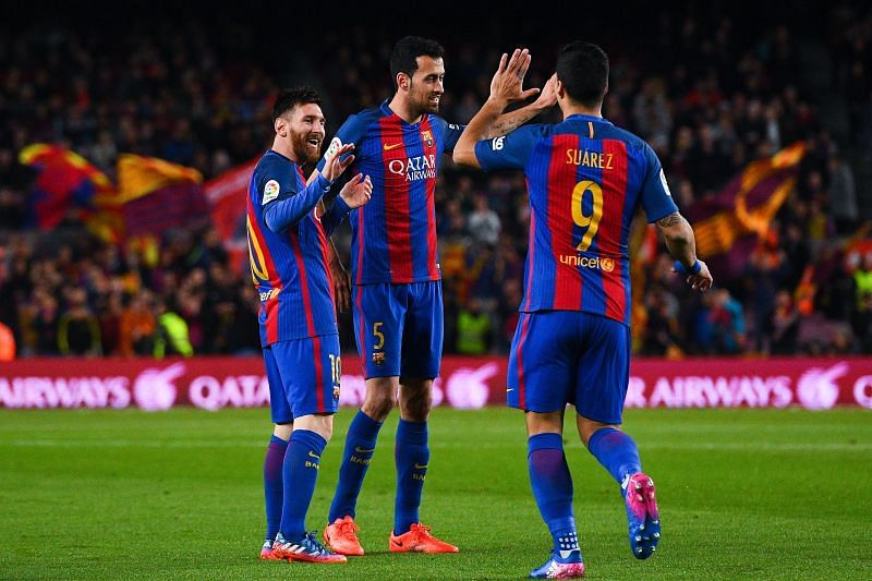 Sergio Busquets (centre) played over 500 games with Lionel Messi.