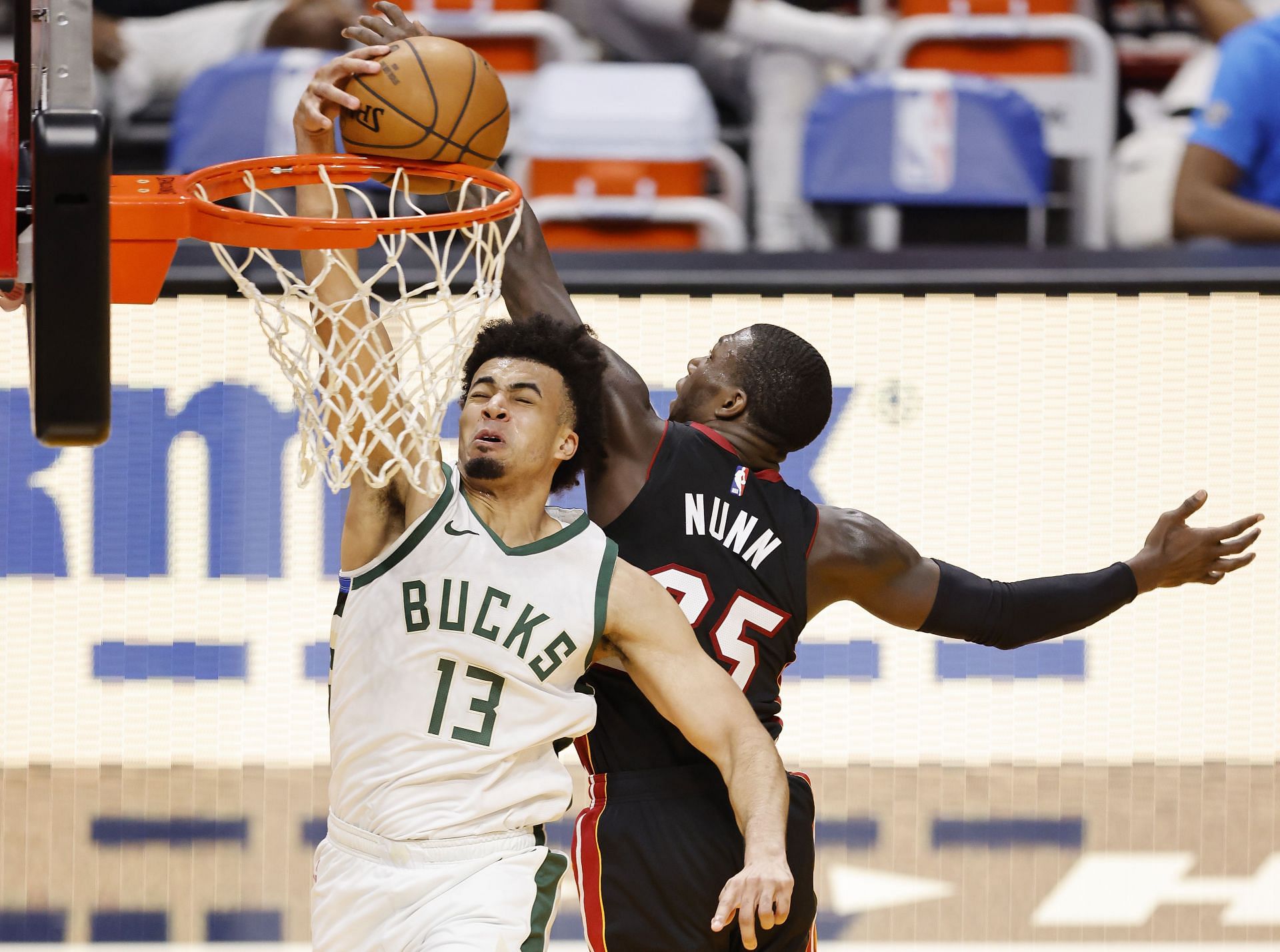 Kendrick Nunn #25 of the Miami Heat blocks a dunk by Jordan Nwora #13 of the Milwaukee Bucks 