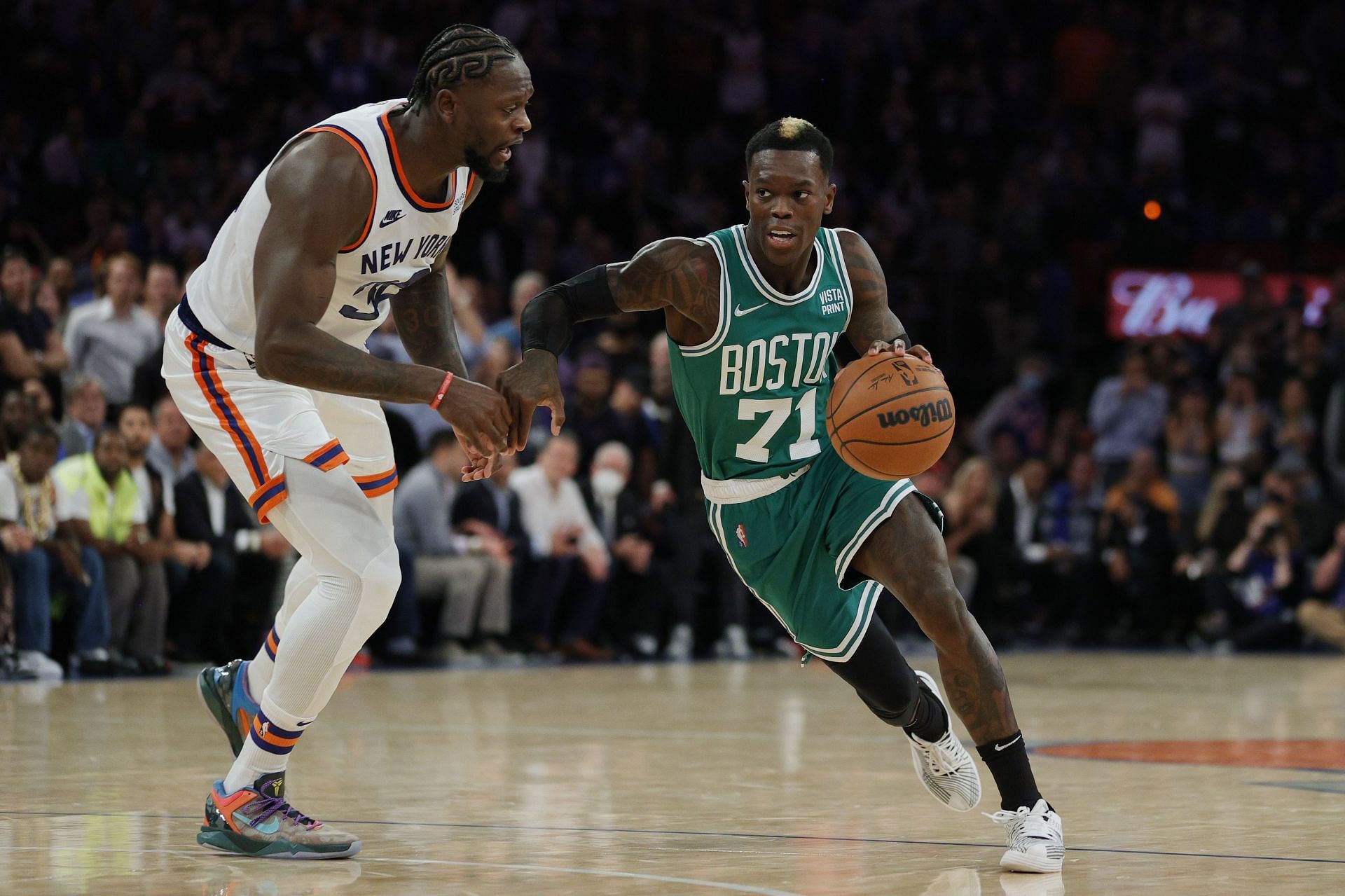 Dennis Schroder #71 of the Boston Celtics dribbles as Julius Randle #30 of the New York Knicks defends