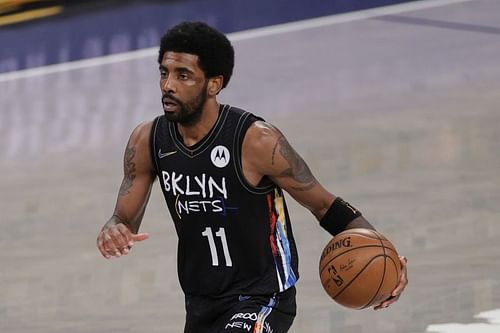 Kyrie Irving brings the ball up the court in the NBA playoffs between the Brooklyn Nets and Milwaukee Bucks