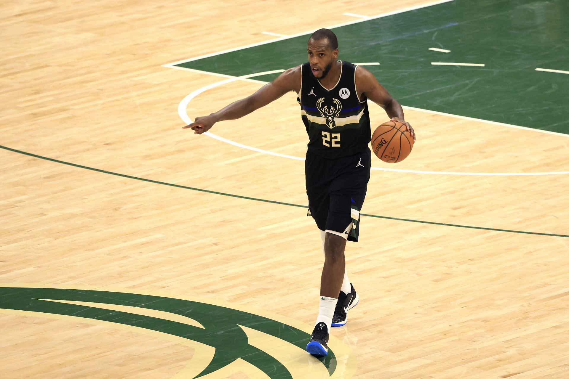 Khris Middleton #22 of the Milwaukee Bucks brings the ball up court against the Phoenix Suns during the second half in Game Six of the NBA Finals at Fiserv Forum on July 20, 2021 in Milwaukee, Wisconsin.