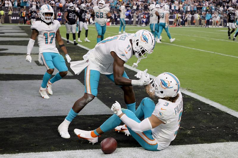 Miami Dolphins wide receiver Will Fuller (#3) getting helped up