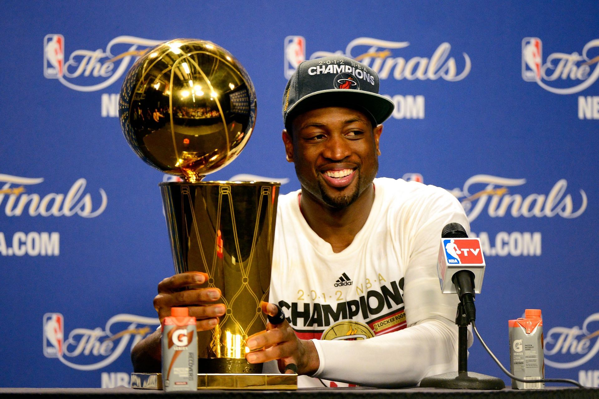 Dwyane Wade #3 of the Miami Heat smiles next to the Larry O&#039;Brien Finals Championship trophy after they won 121-106 against the Oklahoma City Thunder in Game Five of the 2012 NBA Finals on June 21, 2012 at American Airlines Arena in Miami, Florida.