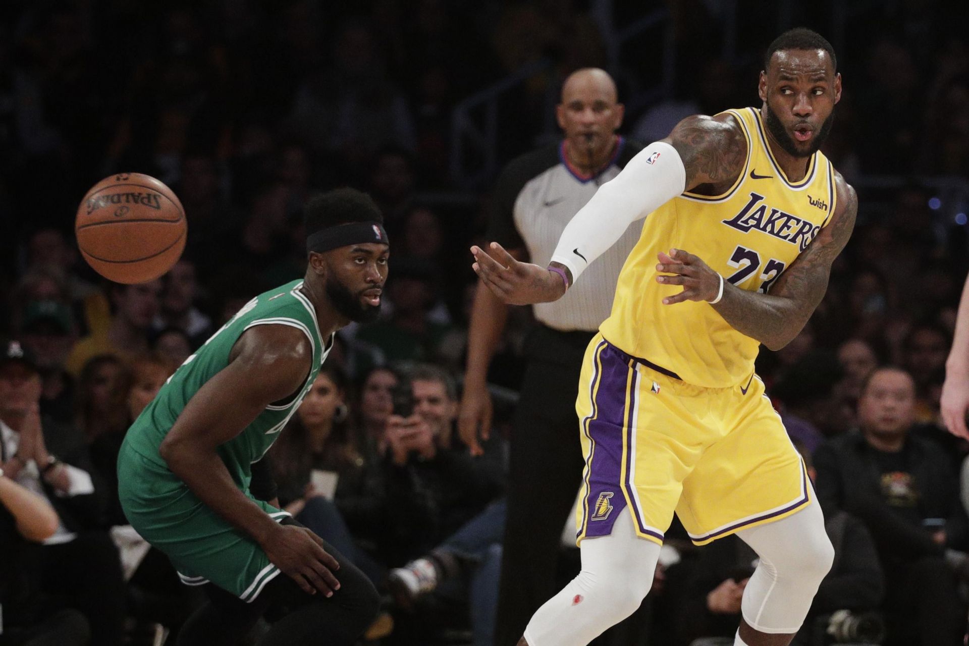 LeBron James passes the ball past Jaylen Brown in the 2029-20 NBA season [Source: AP]