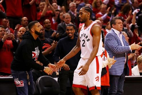 Singer and rapper Drake high-fives Kawhi Leonard during an NBA Playoffs game