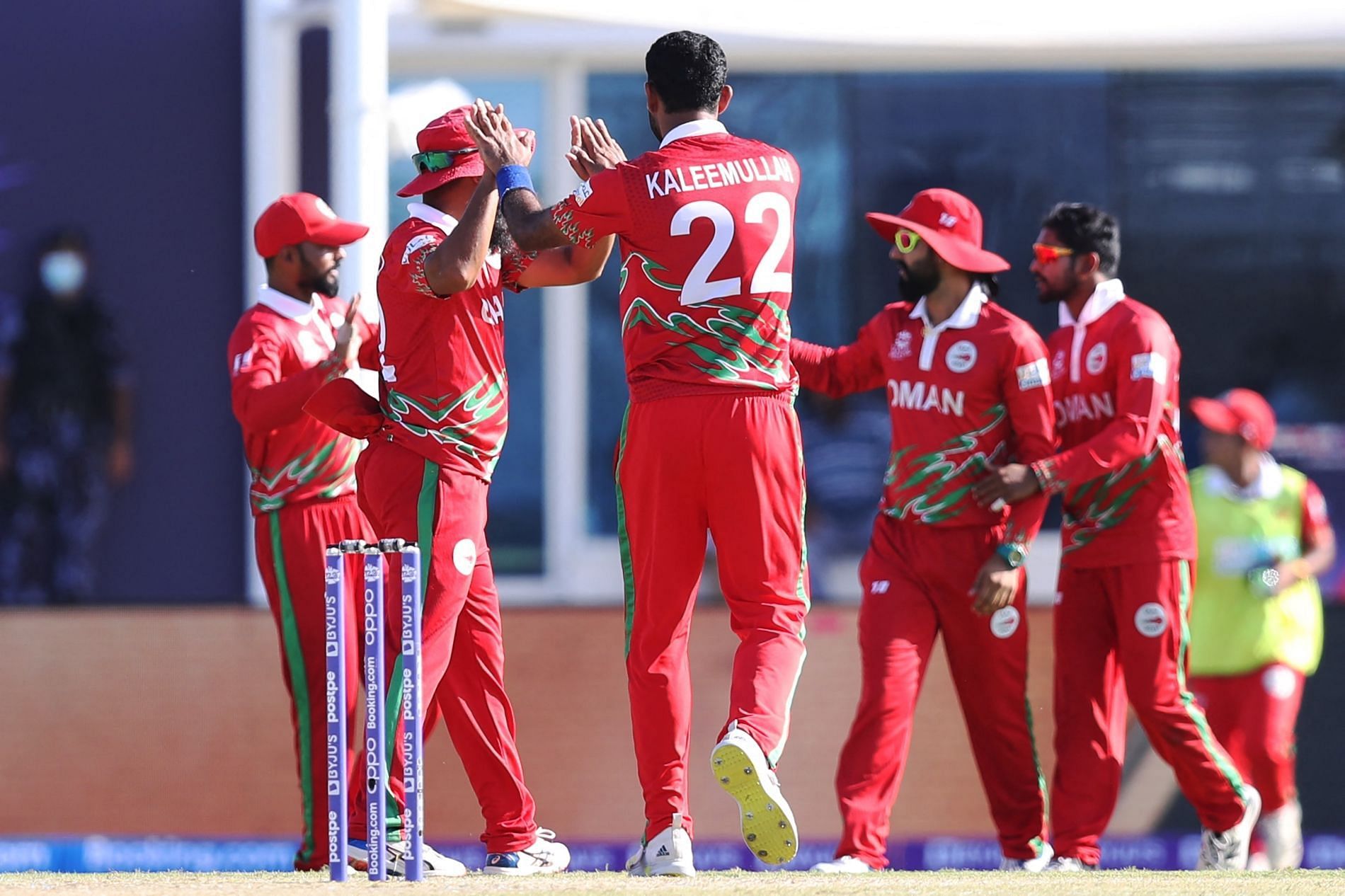 Oman players celebrate a wicket. Pic: T20WorldCup/ Twitter