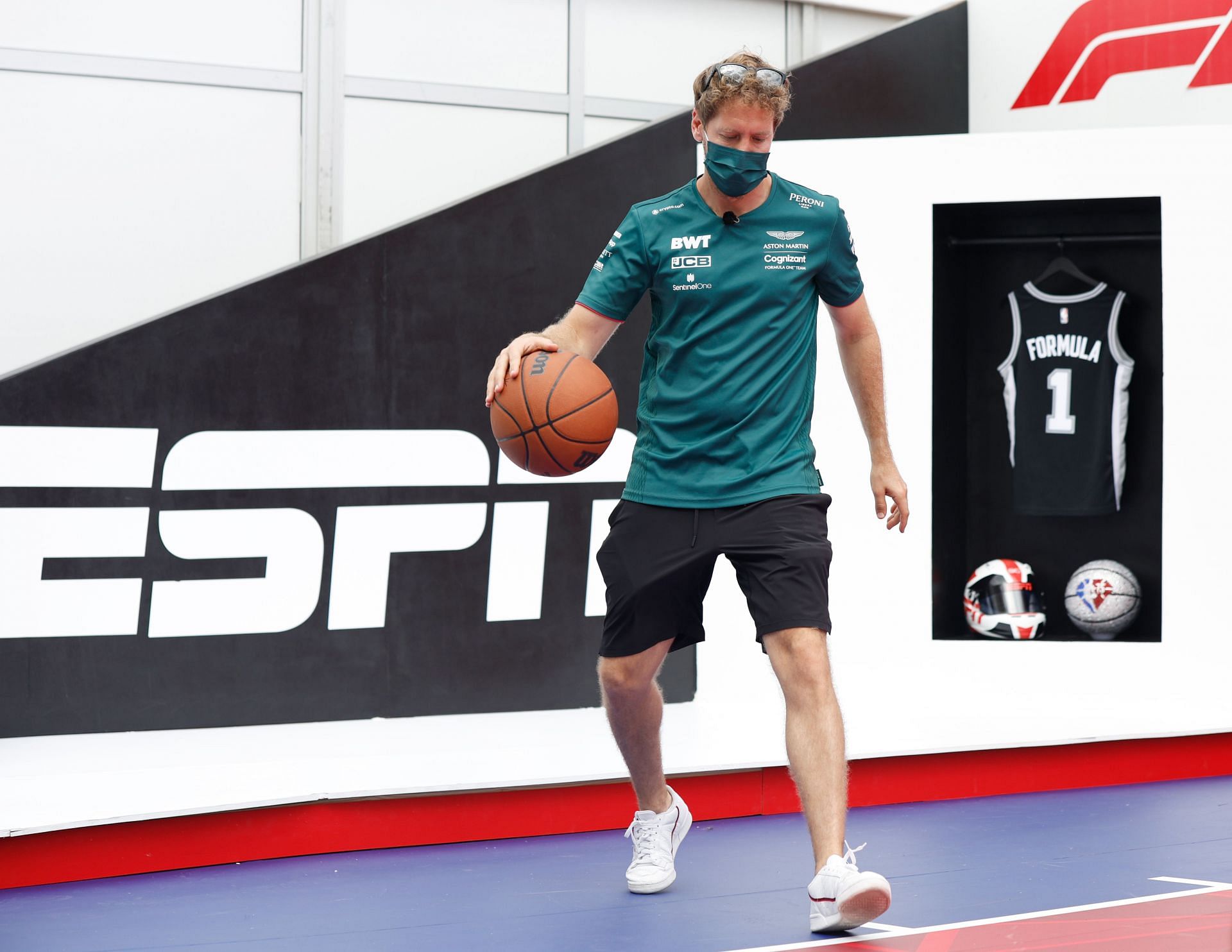 Sebastian Vettel of Aston Martin F1 Team plays basketball on the NBA court in the Paddock during previews ahead of the F1 Grand Prix of USA at Circuit of The Americas in Austin, Texas. (Photo by Jared C. Tilton/Getty Images)