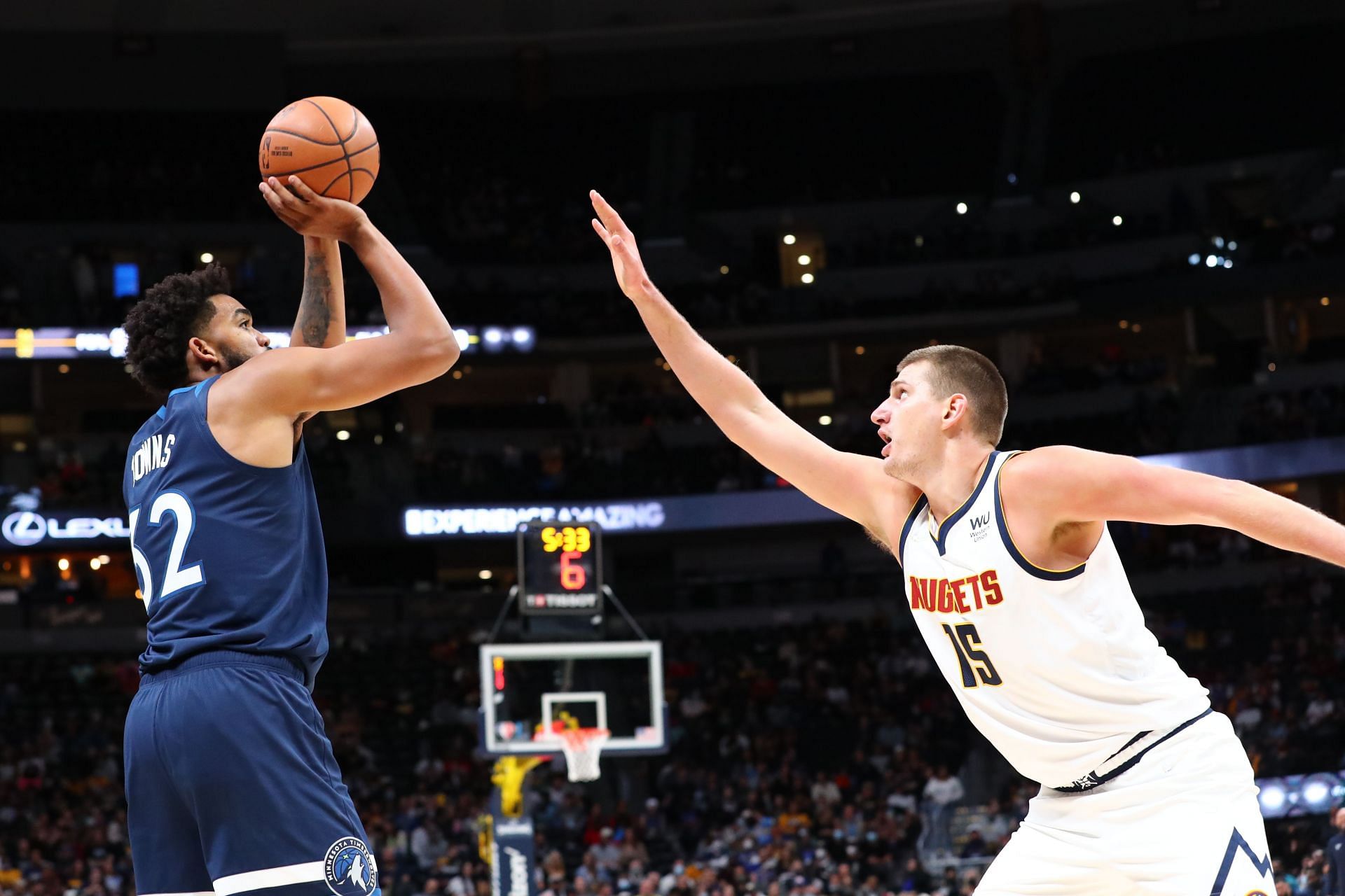 Karl-Anthony Towns #32 of the Minnesota Timberwolves shoots the ball over Nikola Jokic #15 of the Denver Nuggets during the second quarter at Ball Arena on October 8, 2021 in Denver, Colorado.