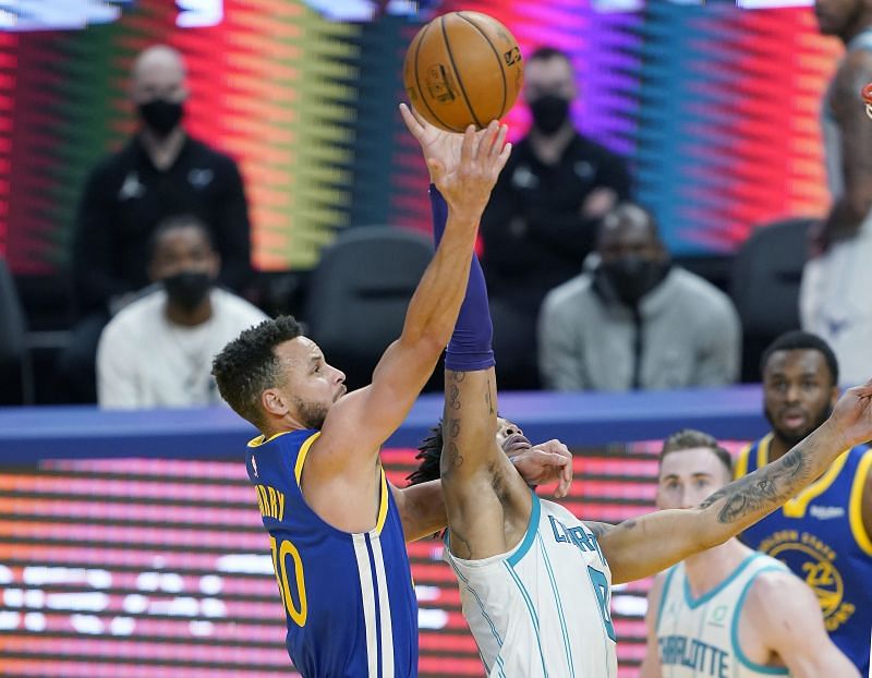 Stephen Curry #30 of the Golden State Warriors shoots over Miles Bridges #0 of the Charlotte Hornets during the second half of an NBA basketball game at Chase Center on February 26, 2021 in San Francisco, California.
