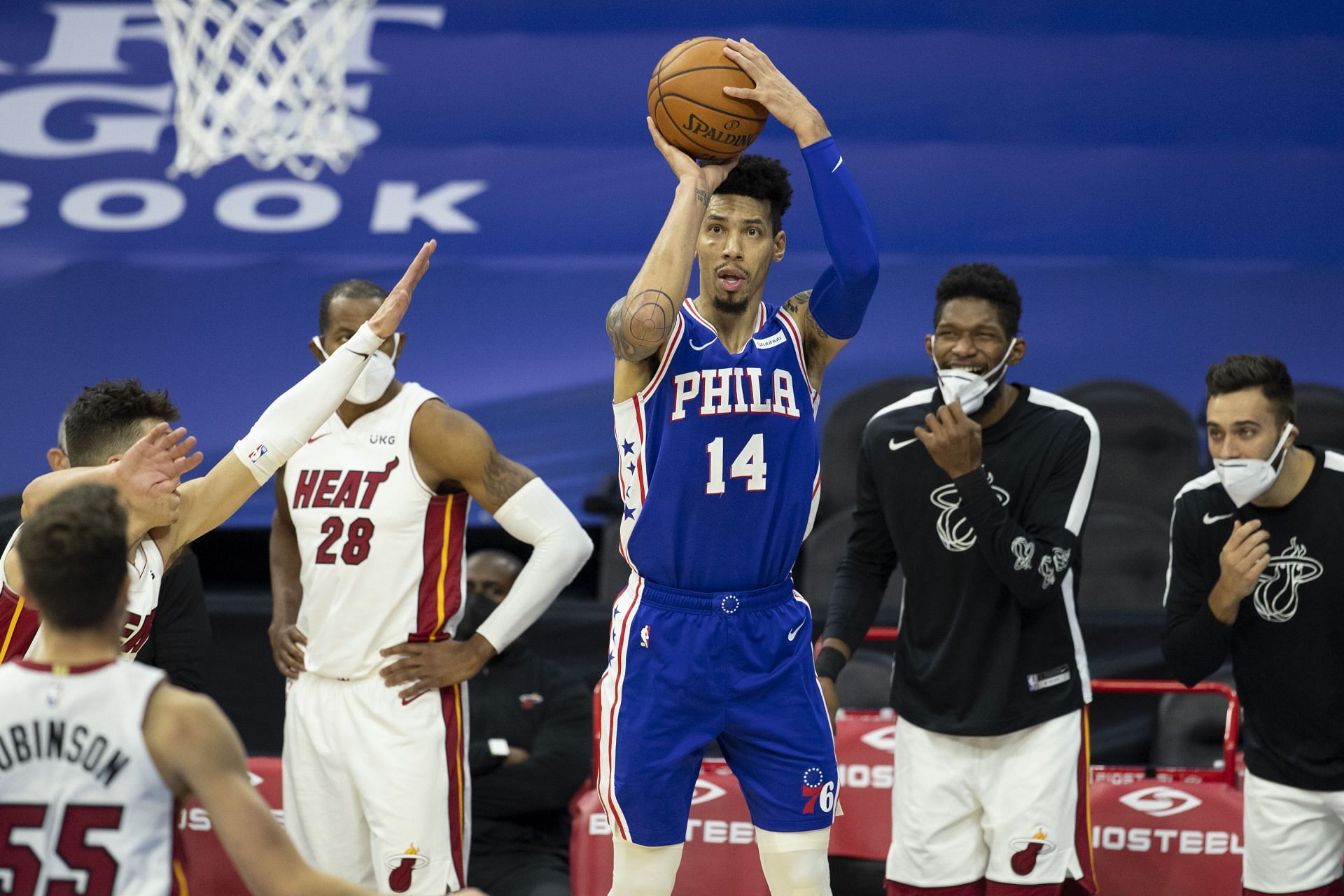 Danny Green #14 of the Philadelphia 76ers shoots the ball in front of the Miami Heat bench in overtime at the Wells Fargo Center on January 12, 2021 in Philadelphia, Pennsylvania. The 76ers defeated the Heat 137-134.