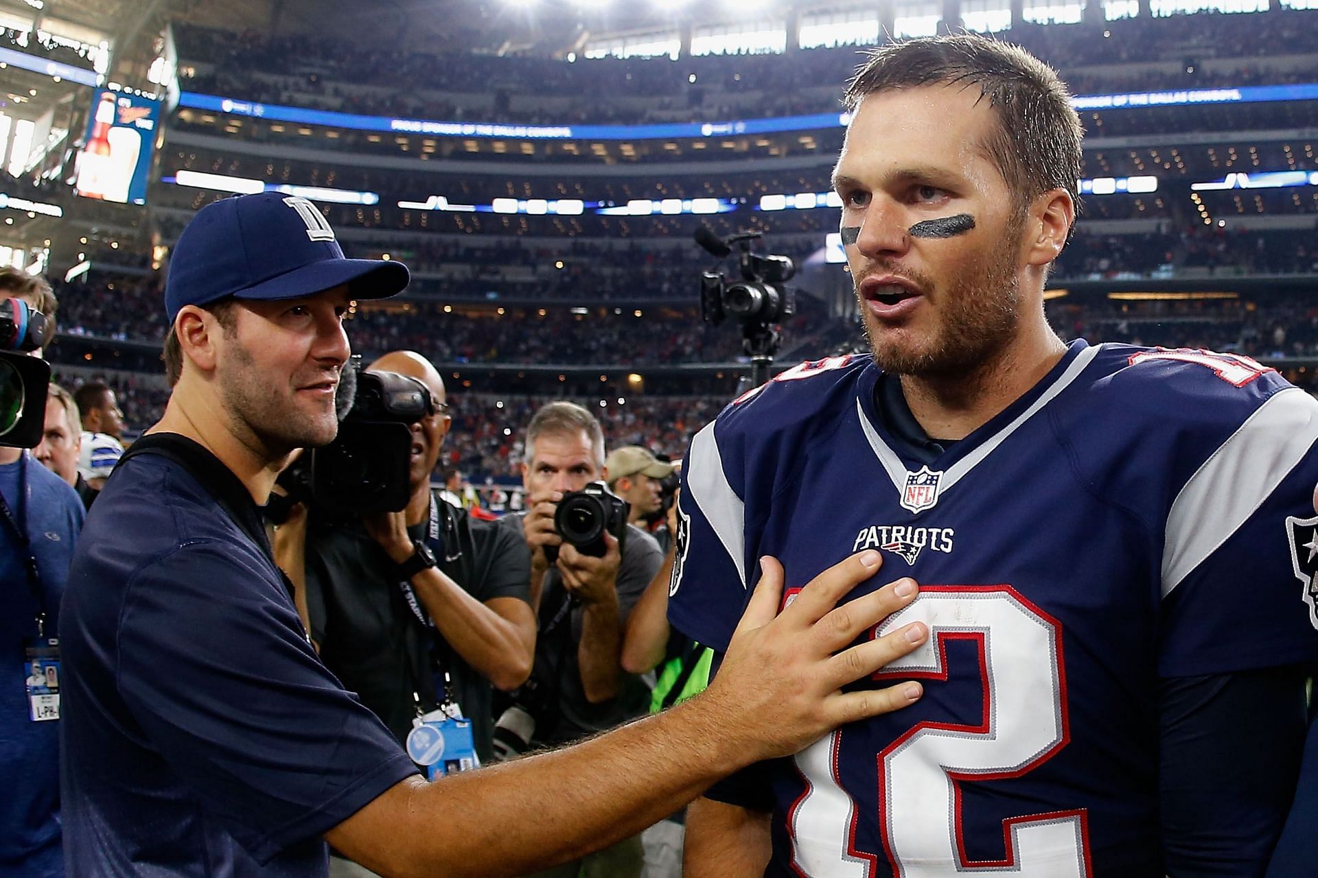 Former Dallas Cowboys quarterback Tony Romo and former New England Patriots quarterback Tom Brady