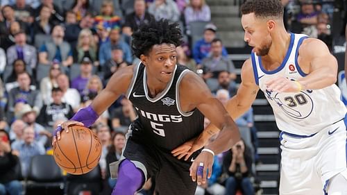 De'Aaron Fox of the Sacramento Kings against Golden State Warriors' Stephen Curry [Source: USA Today]