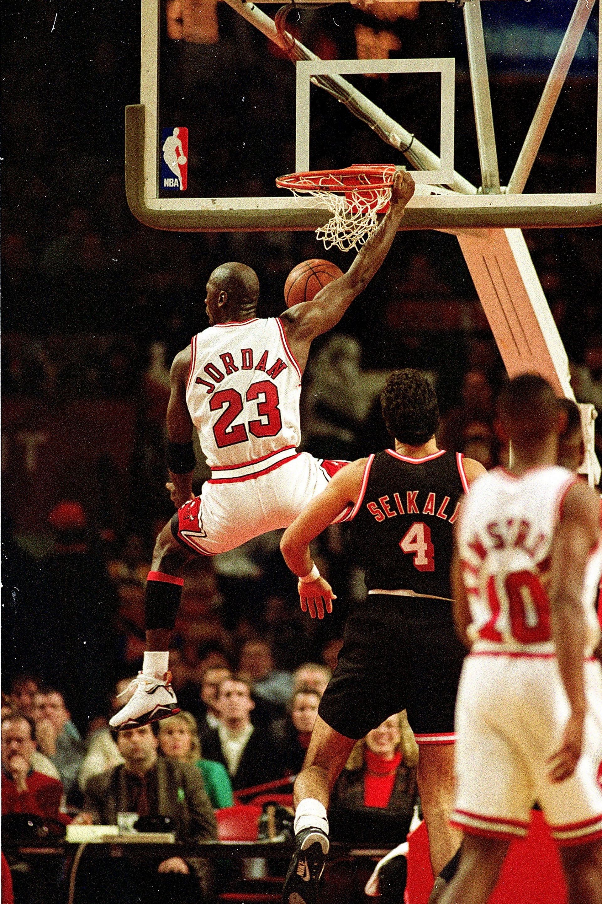 Michael Jordan #23 of the Chicago Bulls dunks the ball during the game against the Miami Heat.