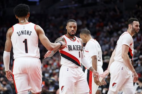 Damian Lillard (#0) of the Portland Trail Blazers high-fives his teammates.