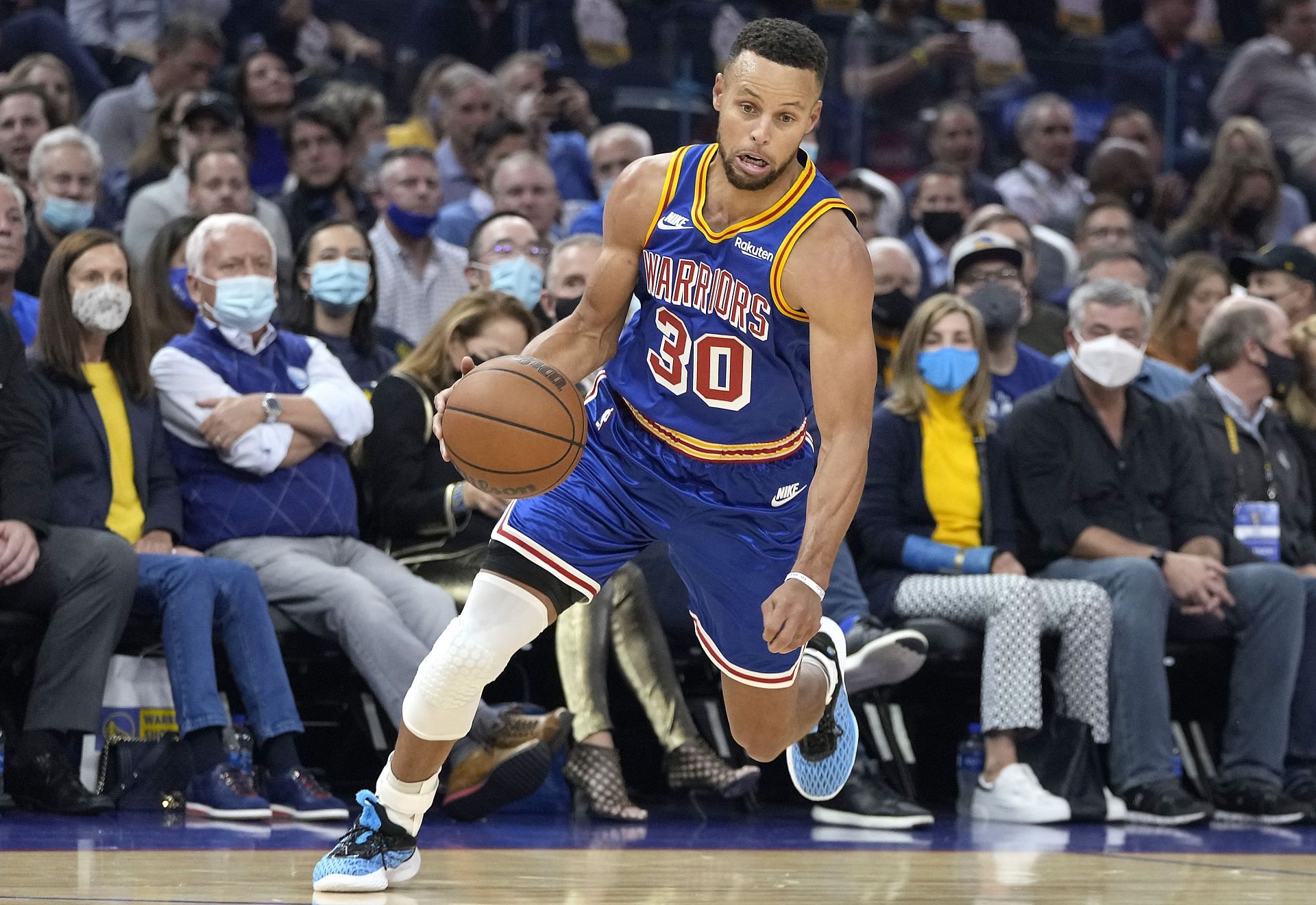 Golden State Warriors superstar Stephen Curry dribbling up the court