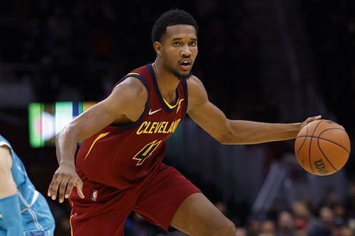 Cleveland Cavaliers forward Evan Mobley surveys the court while dribbling