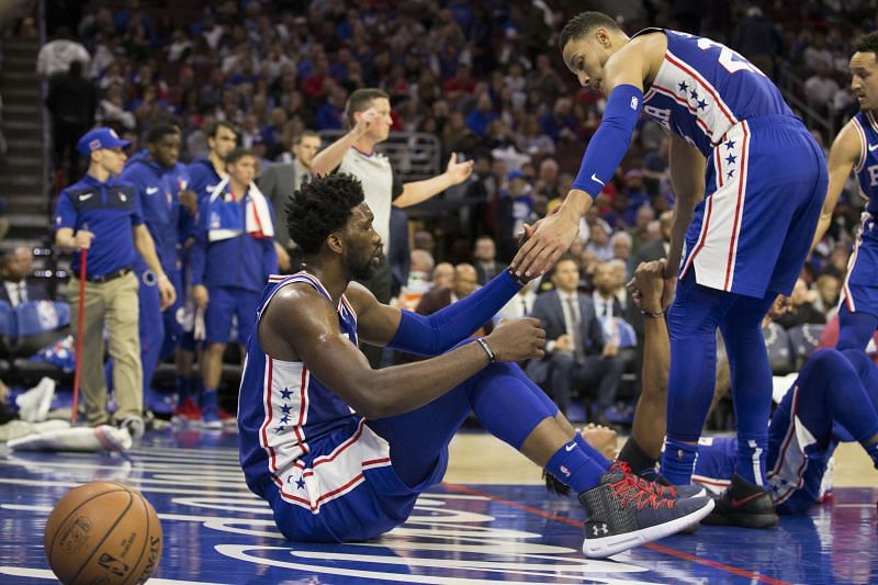 Ben Simmons helping Joel Embiid get back on his feet after scoring