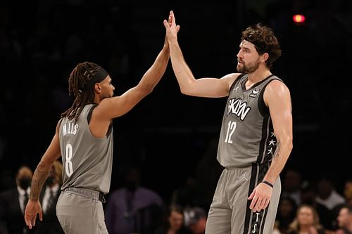 Patty Mills #8 high-fives Joe Harris #12 of the Brooklyn Nets