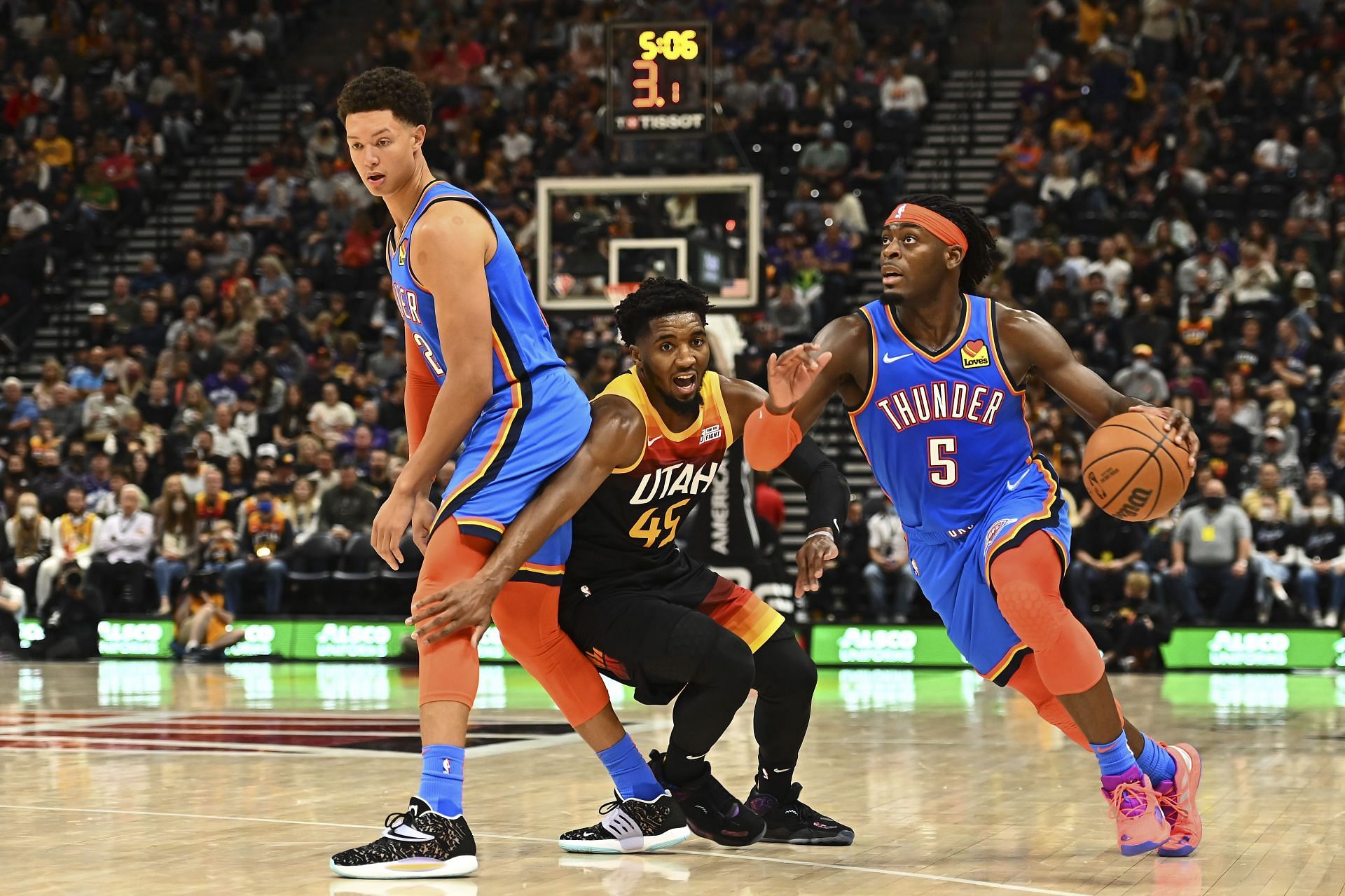 Luguentz Dort uses the screen to drive past Donovan Mitchell.