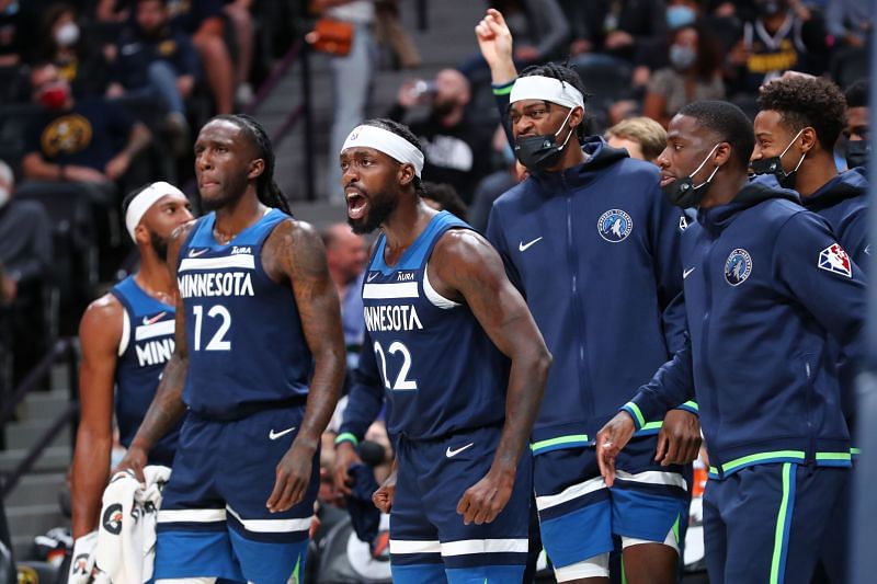 Patrick Beverley #22 of the Minnesota Timberwolves and the bench react against the Denver Nuggets