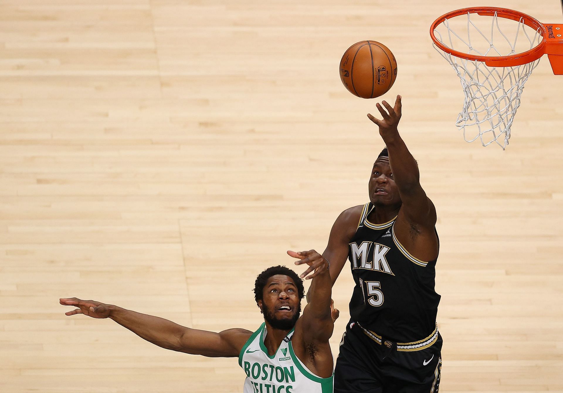 Clint Capela #15 of the Atlanta Hawks battles for a rebound against Semi Ojeleye #37 of the Boston Celtics during the first half at State Farm Arena on February 24, 2021 in Atlanta, Georgia.