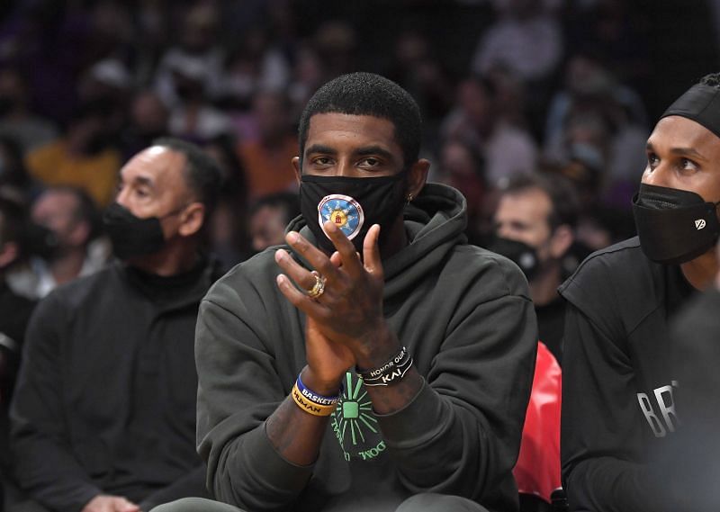Kyrie Irving sits on the Brooklyn Nets&#039; bench in the preseason opener
