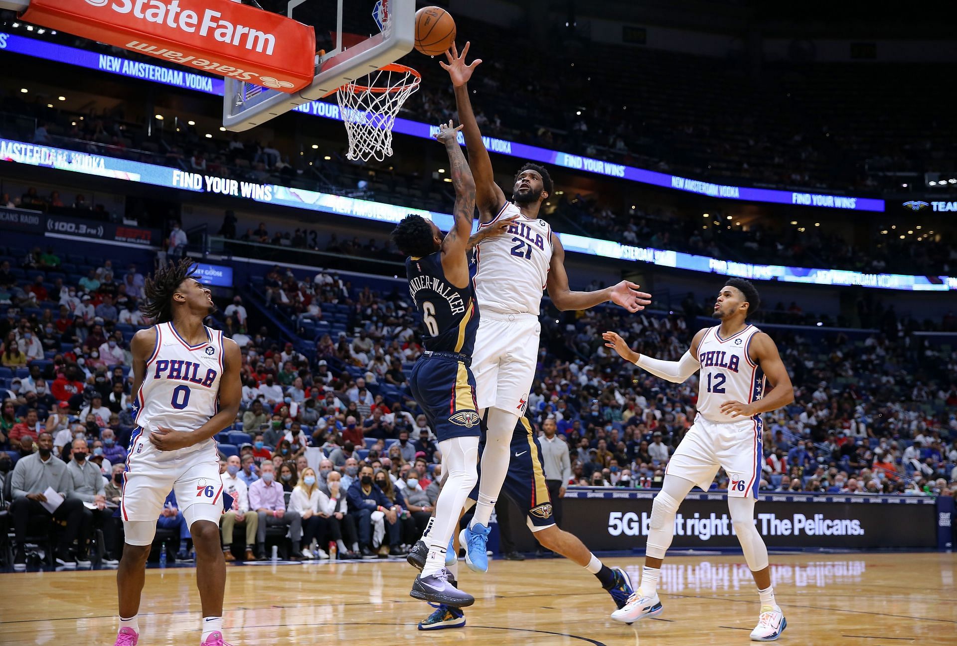 Joel Embiid (#21) of the Philadelphia 76ers blocks a shot from Nickeil Alexander-Walker (#6) of the New Orleans Pelicans.