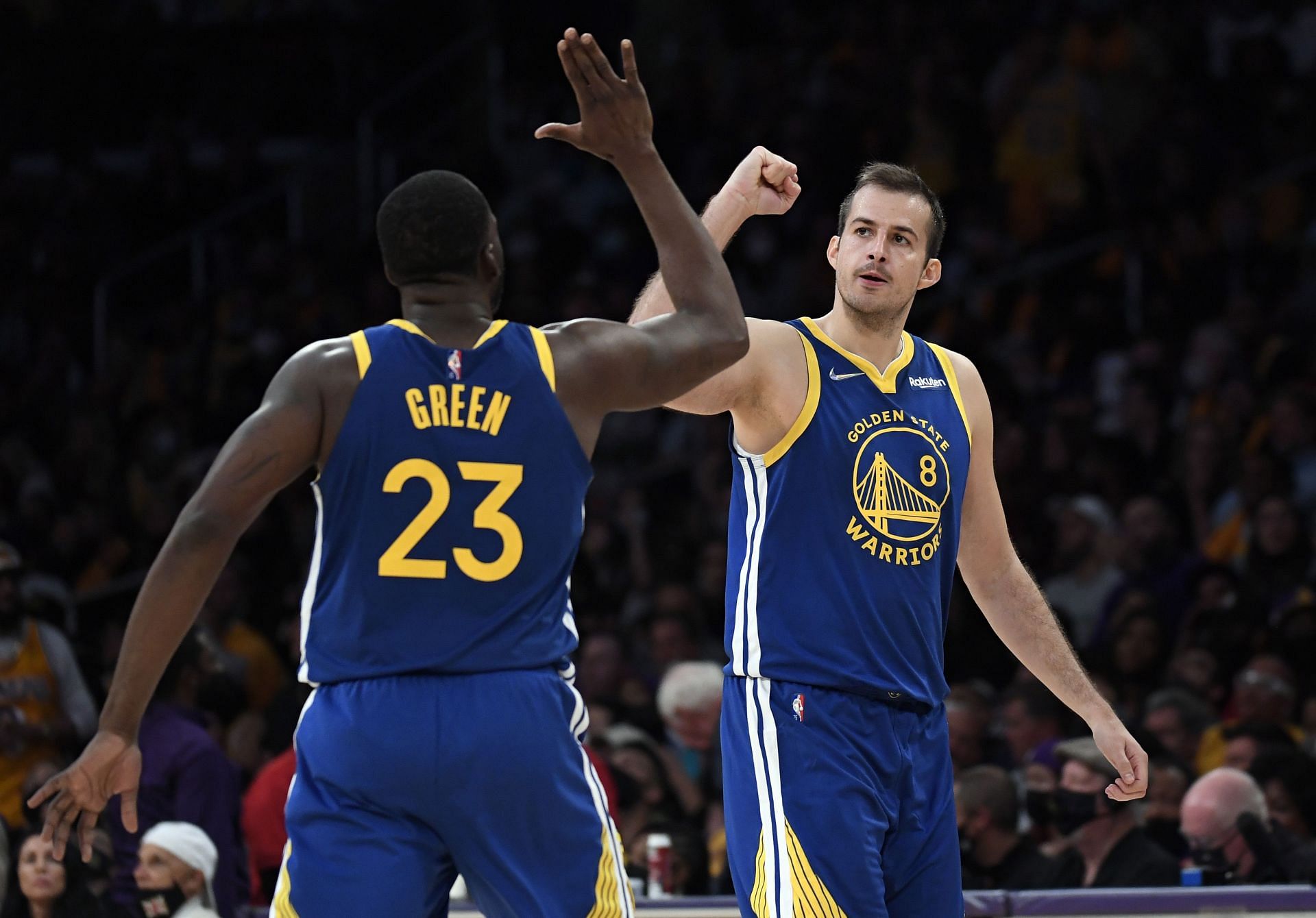Nemanja Bjelica #8 of the Golden State Warriors is congratulated by Draymond Green #23 after scoring against Los Angeles Lakers during the second half at Staples Center on October 19, 2021 in Los Angeles, California.