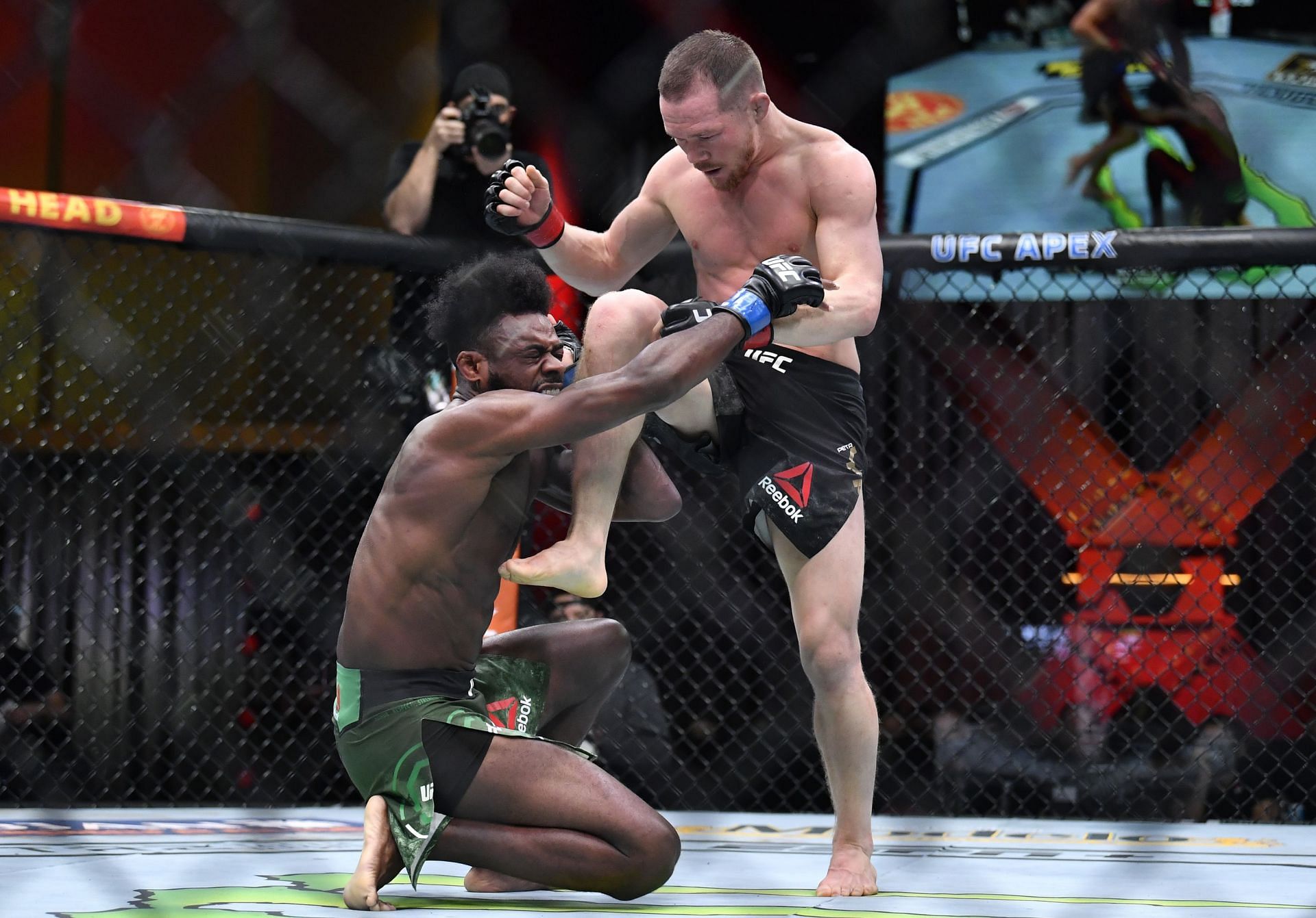 Petr Yan knees Aljamain Sterling illegally [Photo credit: Chris Unger/Zuffa LLC]